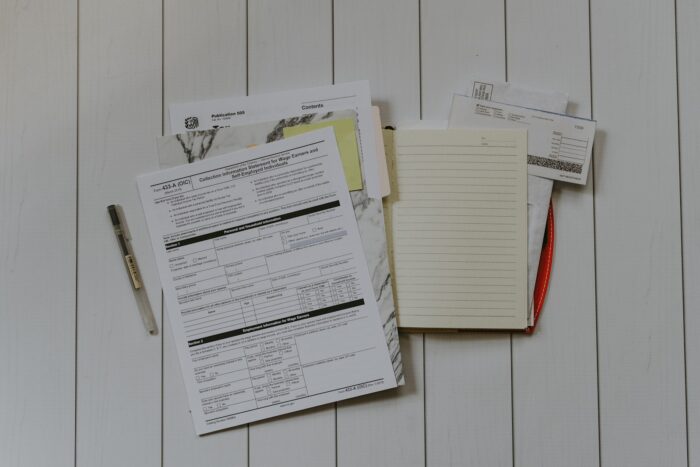 A residential mailbox overflowing with envelopes and catalogs