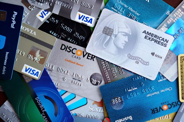 How to Stop Credit Card Offers? A pile of cards including Discover, AmEx.
